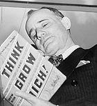 Napoleon Gill holding his book Think and Grow Rich
