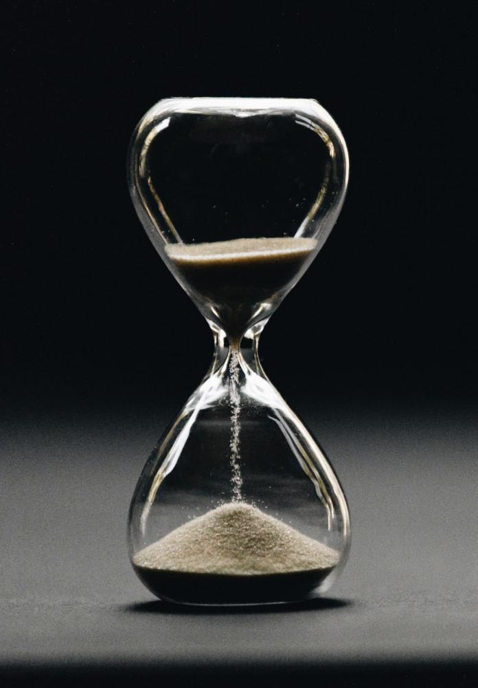 Building a Website Can Take Time Hour glass on dark background Building a Website Can Take Time