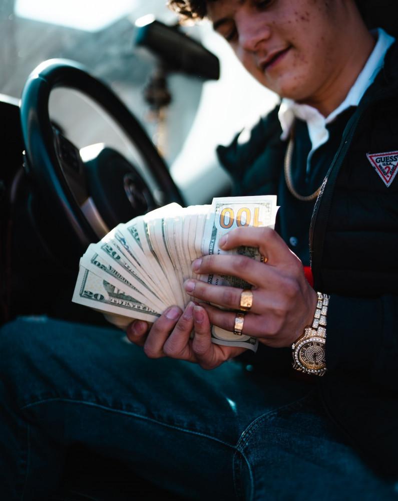Man showing money in car Affiliate Marketing is not a get-rich-quick method. Affiliate Marketing is not a get-rich-quick method.