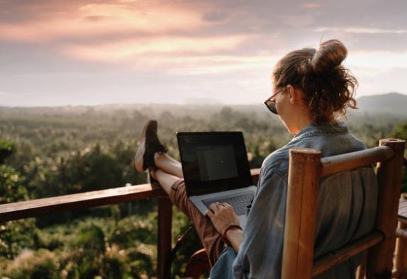 Women sitting down with her laptop enjoying the freedom and flexibility of affiliate marketing Women sitting down with her laptop enjoying the freedom and flexibility of affiliate marketing while outside in the sunshine and forests