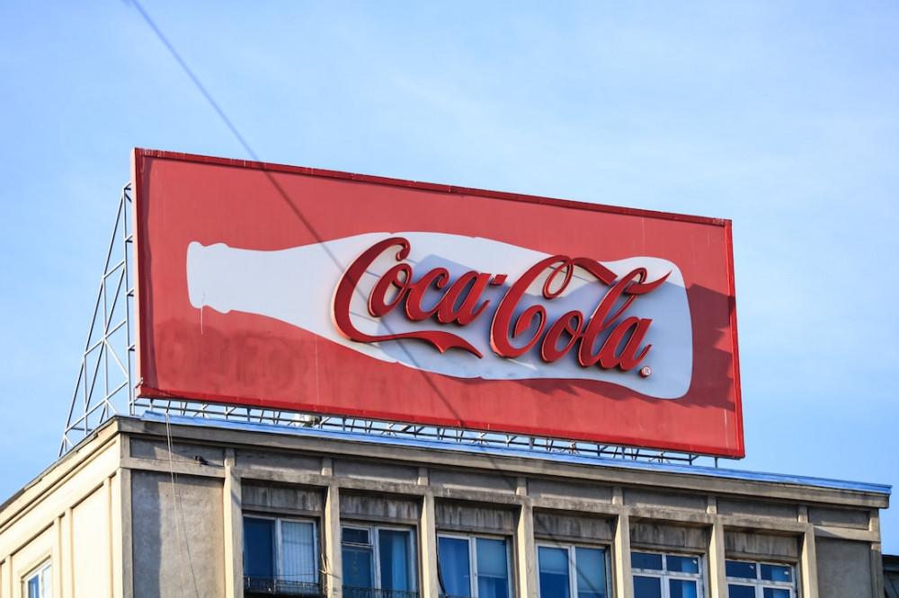 Coka-Cola on red billboard sign regarding paid advertising sample Coka-Cola on red billboard sign regarding paid advertising sample