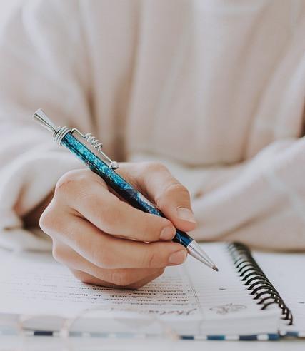Person use a pen and notebook to write ideas for affilaite marketing Person use a pen and notebook to write ideas for affilaite marketing